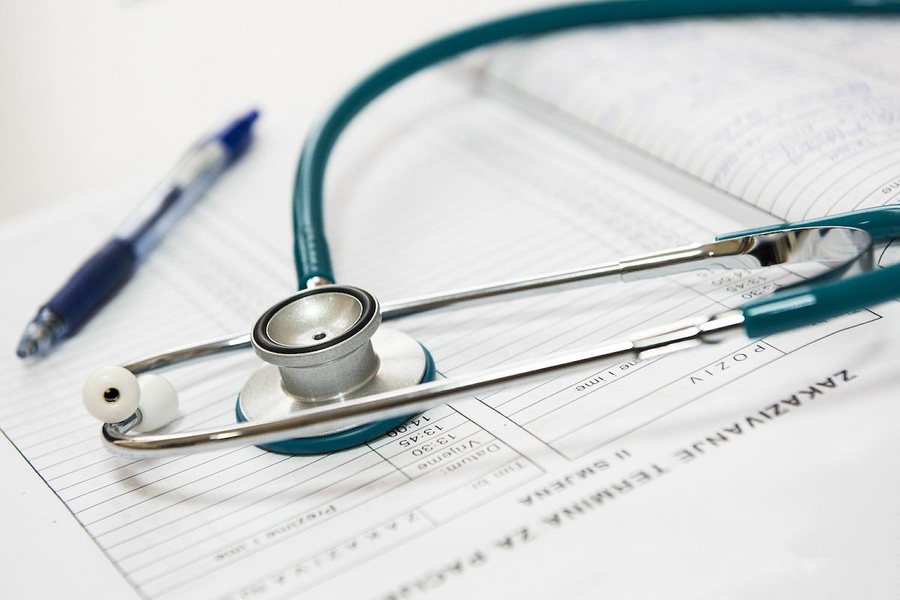 A stethoscope resting on medical notes
